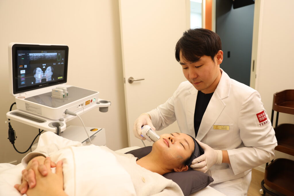 Board-certified dermatologist Dr. Dongju Hyun at TERRA Dermatology Clinic, performing a non-surgical face lift using the 2nd generation Ultherapy Prime with real-time ultrasound visualization.